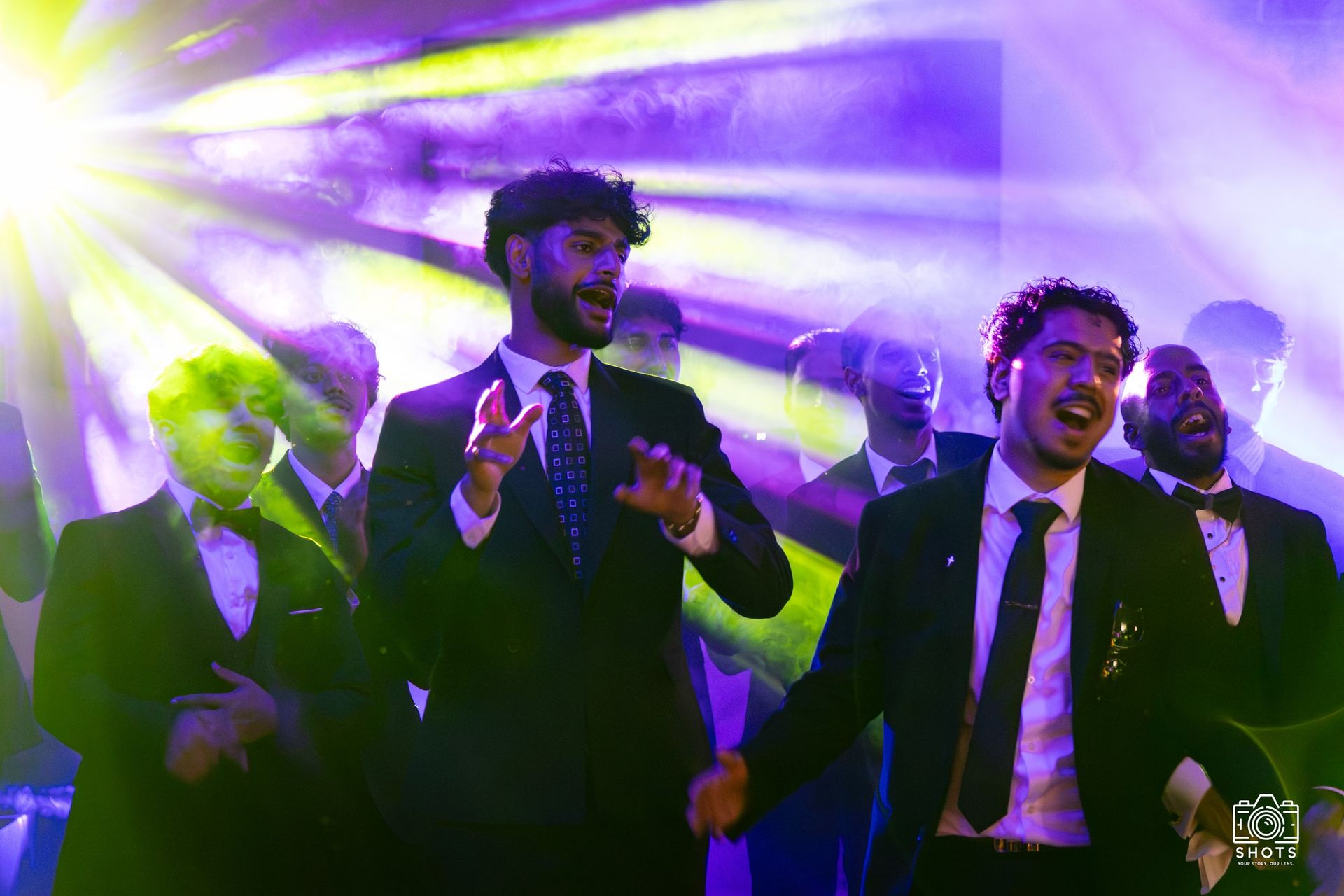 Guests dancing beneath colourful lights at an evening celebration